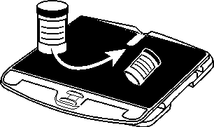 Pill bottle placed in indentation on XY table